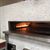 HM630 Ivory is a white glass tile utilized on a restaurant fireplace